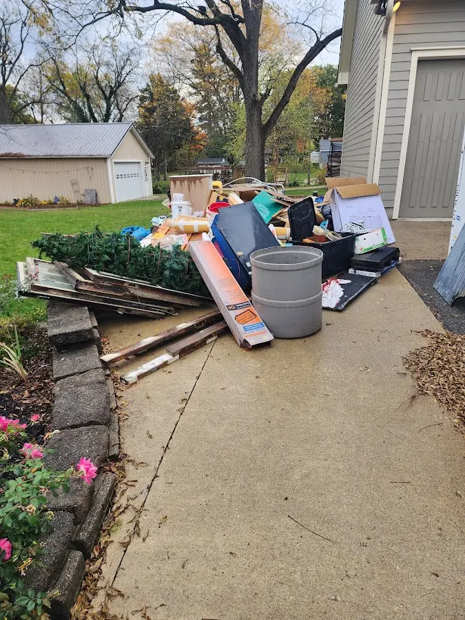 Dumpster being loaded with debris for Estate Cleanout Dumpster Rental in Williams